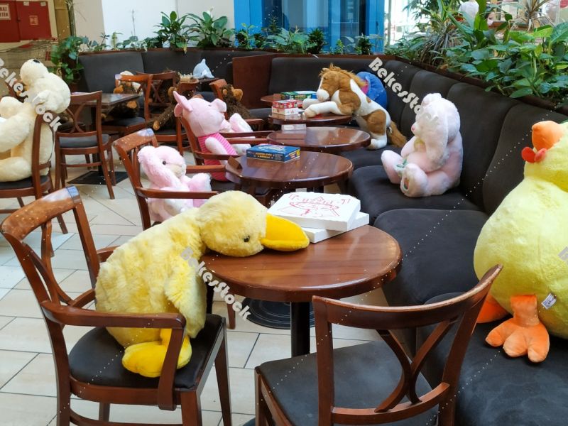 Instead of guests, plush figures sit at tables in the cafe durin