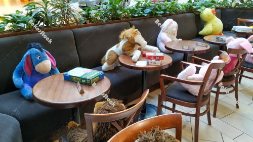 Instead of guests, plush figures sit at tables in the cafe durin Instead of guests, plush figures sit at tables in the cafe durin