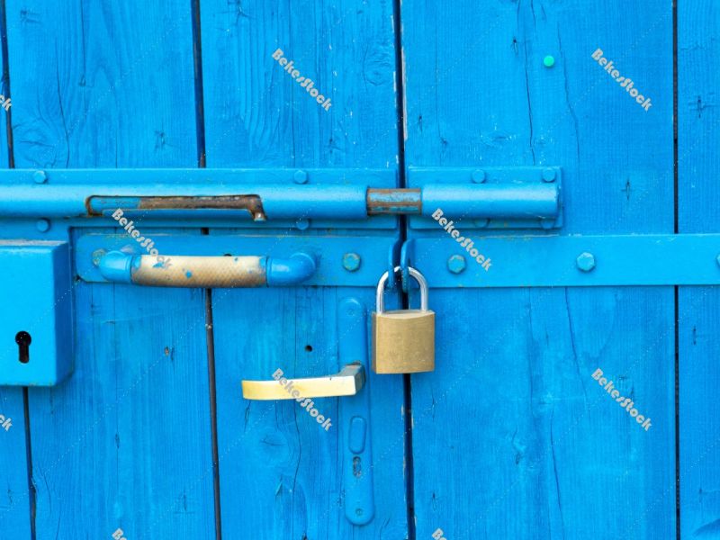 Old style lock and padlock on the blue wooden door - Portoroz, P Old style lock and padlock on the blue wooden door - Portoroz, P