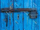 Old-fashioned, rusty lock and padlock on blue wooden door - Port