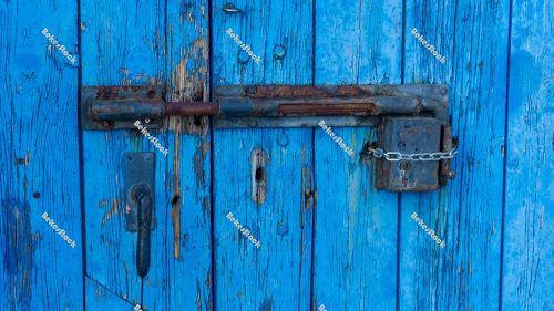 Old-fashioned, rusty lock and padlock on blue wooden door - Port Old-fashioned, rusty lock and padlock on blue wooden door - Port