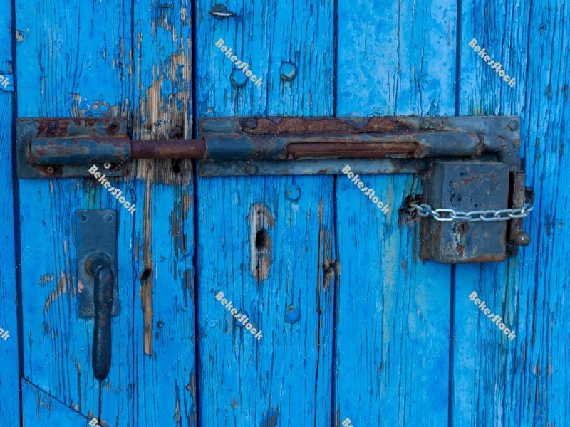 Old-fashioned, rusty lock and padlock on blue wooden door - Port Old-fashioned, rusty lock and padlock on blue wooden door - Port