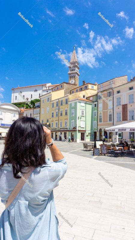 Woman takes photos of Tartini Central Square in Piran. Piran, Ob Woman takes photos of Tartini Central Square in Piran. Piran, Ob