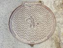 Manhole cover with salt worker illustration. Saltworks `soline` 