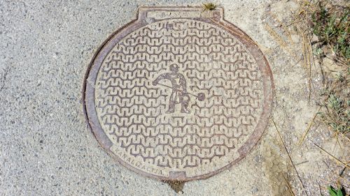 Manhole cover with salt worker illustration. Saltworks `soline` Manhole cover with salt worker illustration. Saltworks `soline`
