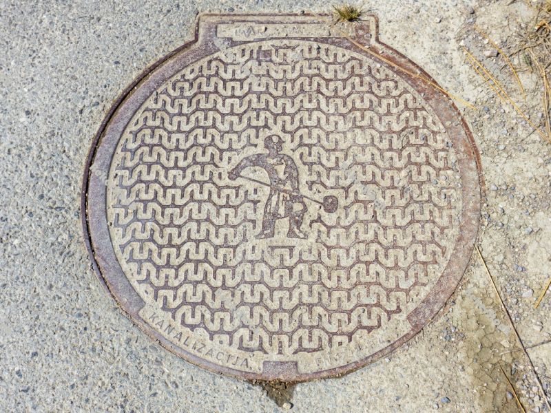 Manhole cover with salt worker illustration. Saltworks `soline`  Manhole cover with salt worker illustration. Saltworks `soline`