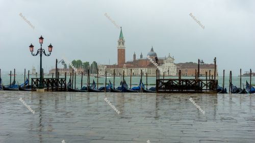 Empty gondolas moored, without tourists in Venice during the cor Empty gondolas moored, without tourists in Venice during the cor