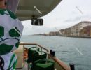 Woman in green patterned medical mask on the water bus. Venice, 
