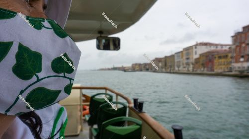 Woman in green patterned medical mask on the water bus. Venice, Woman in green patterned medical mask on the water bus. Venice,