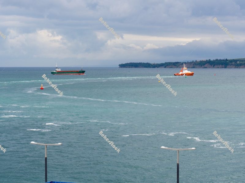 A pilot boat leads a container vessel to port. Luka Koper (`Capo A pilot boat leads a container vessel to port. Luka Koper (`Capo