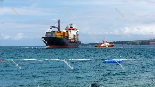 A pilot boat turn over a container vessel in port. Luka Koper (` A pilot boat turn over a container vessel in port. Luka Koper (`