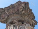 Ancient Roman column capital (head) with blue sky in the backgro