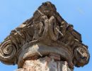 Ancient Roman column capital (head) with blue sky in the backgro