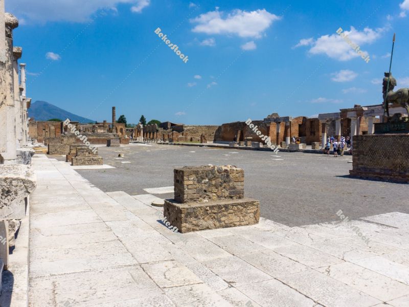 Civil Forum in Pompeii. The blue sky and Mount Vesuvius provide  Civil Forum in Pompeii. The blue sky and Mount Vesuvius provide
