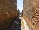 Alley way (`vicolo`) in Pompeii. The narrow street is lined with