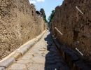 Street (`via`) in Pompeii. The narrow street is lined with stone