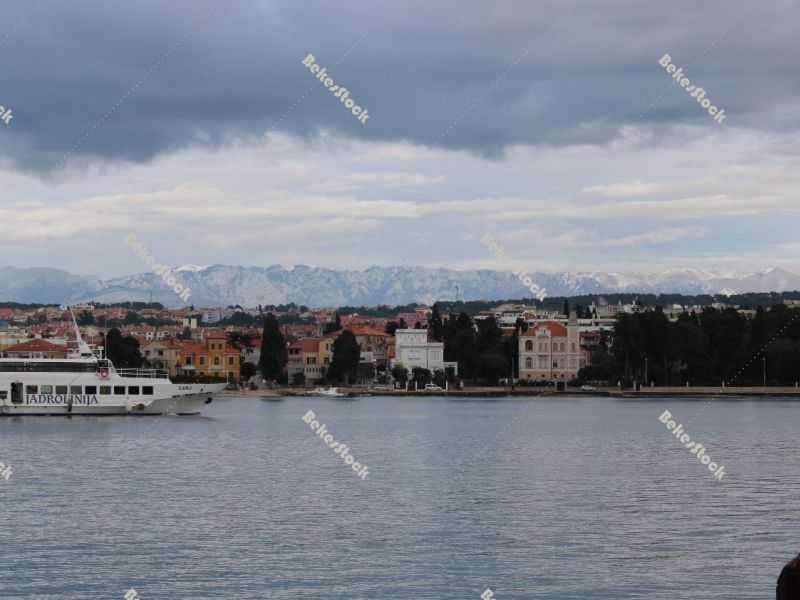 Ship arrives in Zadar, Zadar as seen from the sea with mountains in background, December 2019 Ship arrives in Zadar, Zadar as seen from the sea with mountains in background, December 2019