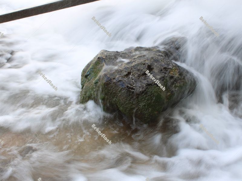 Stone struggles with the elements in the waterfall, `Skradinski Buk` waterfall  - Krka National Park, Lozovac, Croatia Stone struggles with the elements in the waterfall, `Skradinski Buk` waterfall  - Krka National Park, Lozovac, Croatia